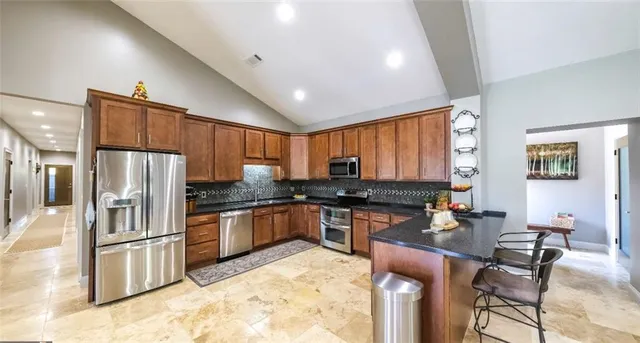 a view of a swimming pool with an outdoor seating and a yard