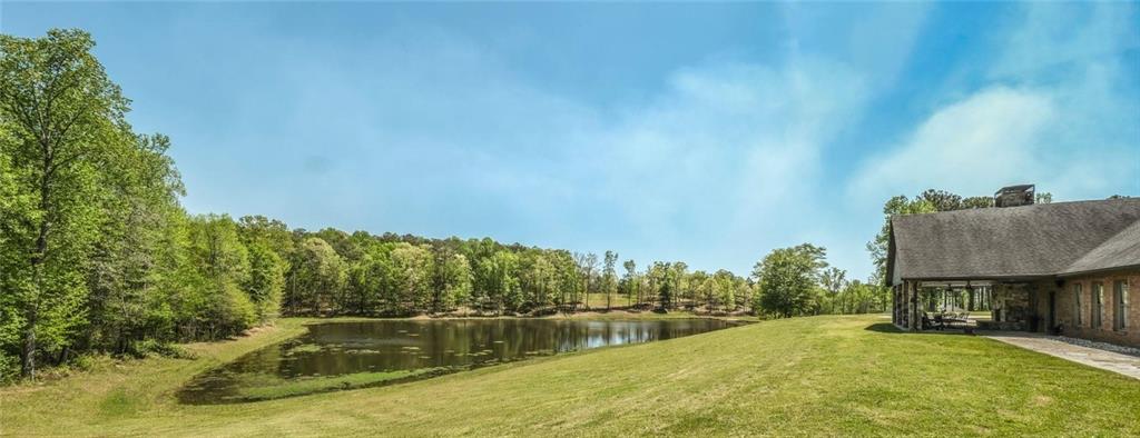 1600 Happy Hollow Road Roopville, GA 30170 - Photo 23 of 41 a view of a swimming pool with an outdoor seating and a yard