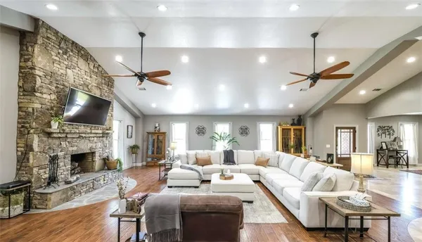 a living room with fireplace furniture and a chandelier