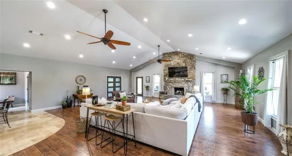 a living room with furniture fireplace and wooden floor