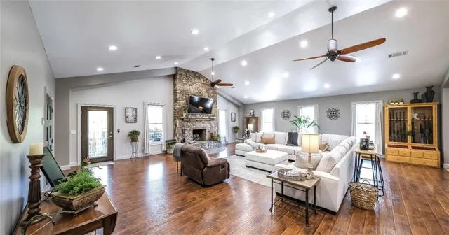 a living room with furniture a window and wooden floor