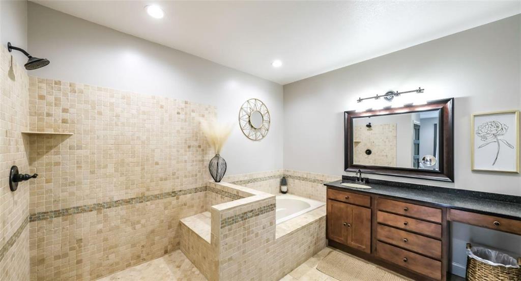 1600 Happy Hollow Road Roopville, GA 30170 - Photo 29 of 41 a bathroom with a sink mirror and a bathtub