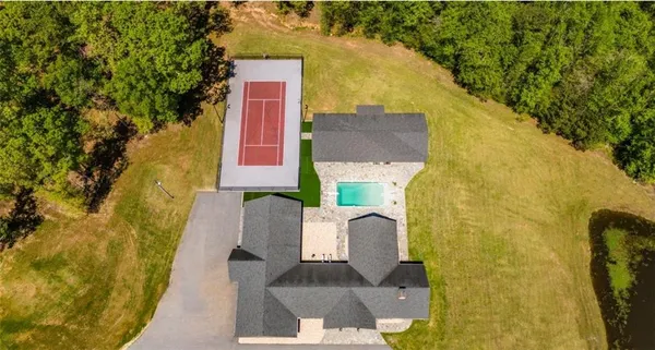 an aerial view of a house with a swimming pool