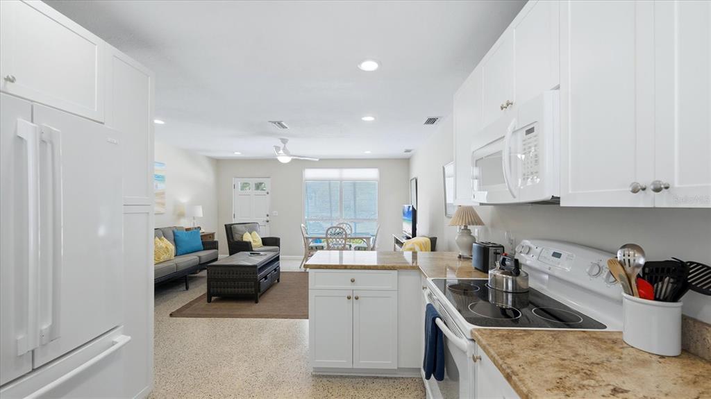 201 Wheeler Road Boca Grande, FL 33921 - Photo 12 of 26 a kitchen with white cabinets and sink