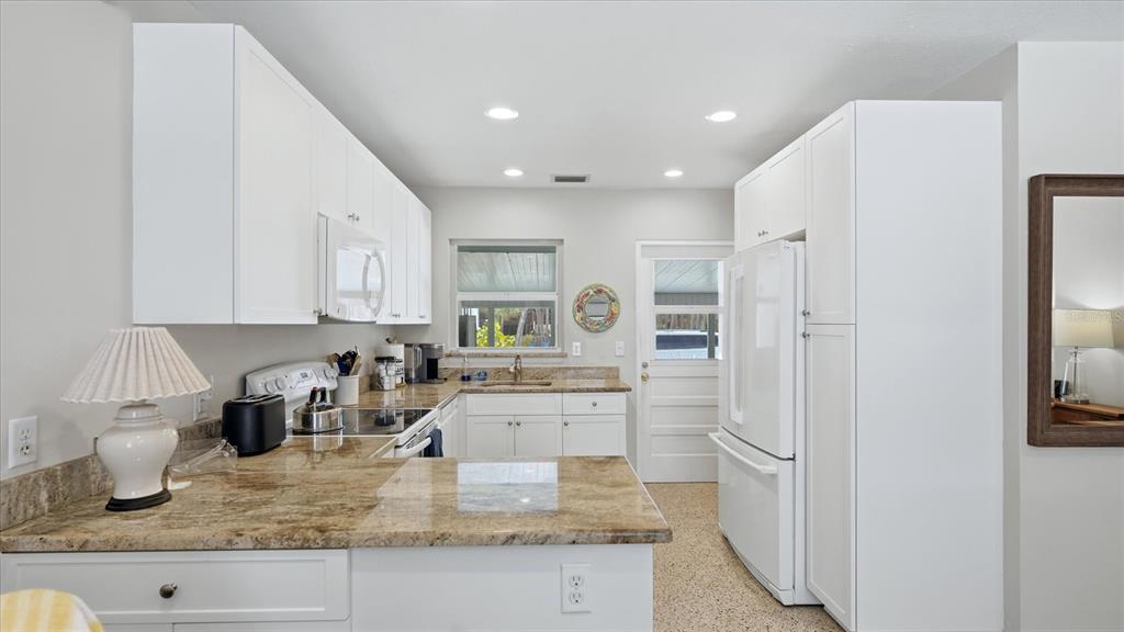 201 Wheeler Road Boca Grande, FL 33921 - Photo 13 of 26 a kitchen with stainless steel appliances granite countertop a refrigerator sink and cabinets