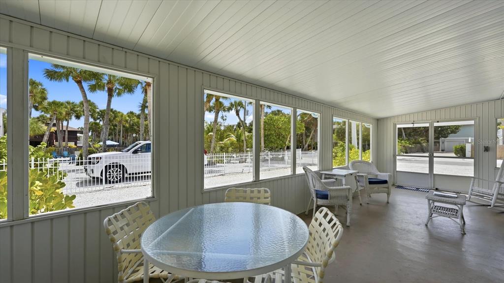 201 Wheeler Road Boca Grande, FL 33921 - Photo 21 of 26 a dining room with furniture water view and a floor to ceiling window