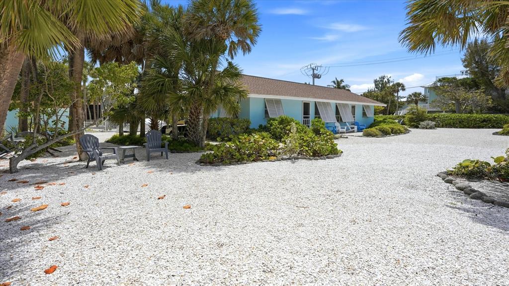 201 Wheeler Road Boca Grande, FL 33921 - Photo 5 of 26 a front view of a house with a yard and a garage