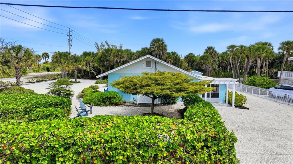 201 Wheeler Road Boca Grande, FL 33921 - Photo 6 of 26 a view of a garden with a bench