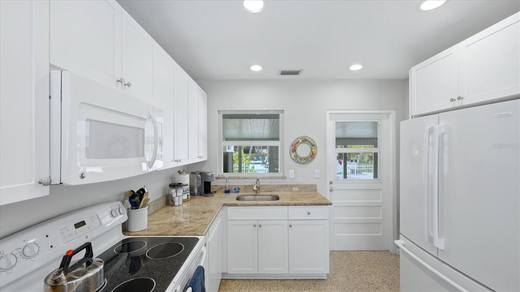 201 Wheeler Road Boca Grande, FL 33921 - Photo 10 of 26 a spacious bathroom with a sink vanity granite and a mirror