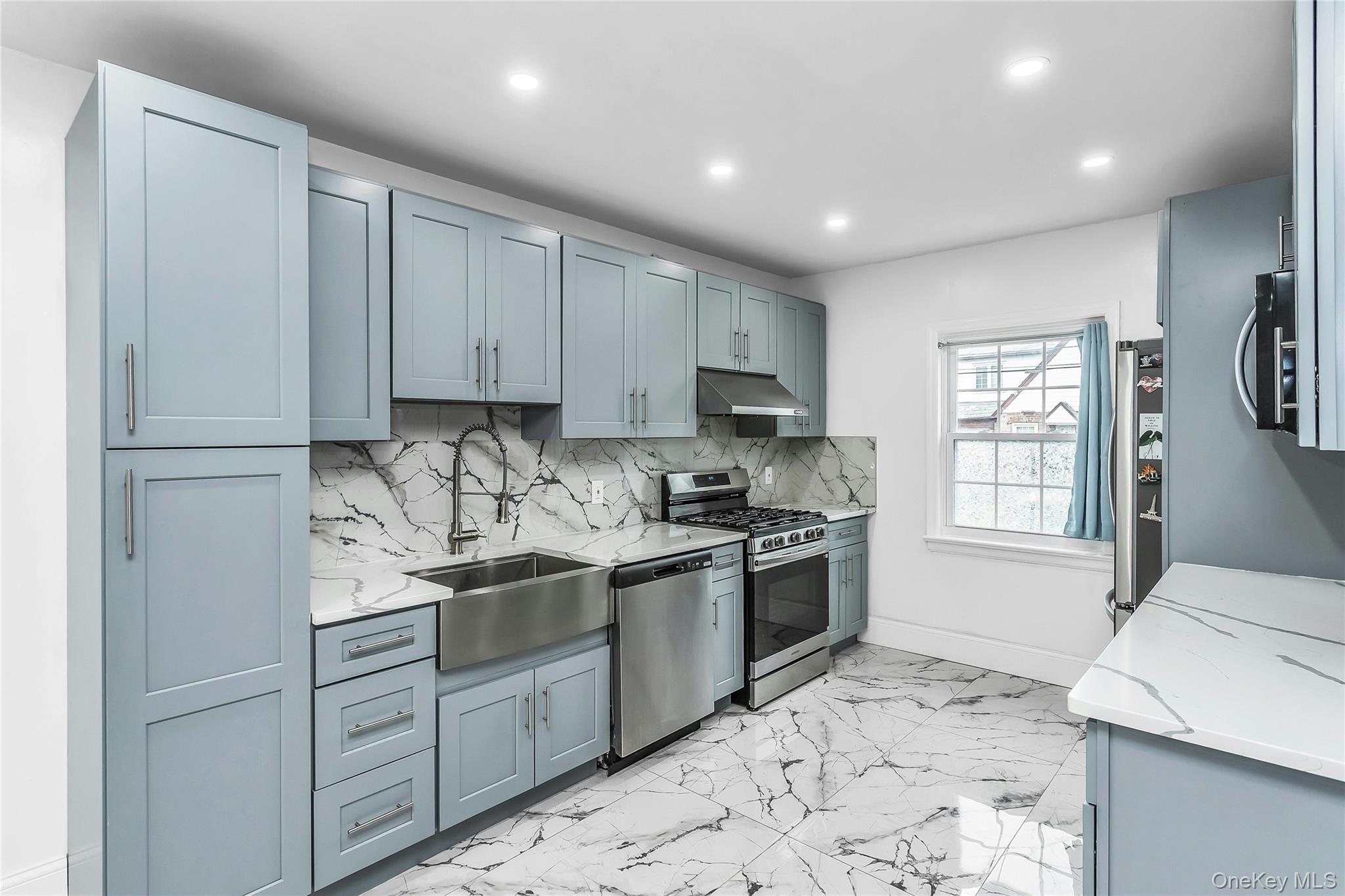 103 Union Street Valley Stream, NY 11580 - Photo 2 of 19 a kitchen with stainless steel appliances granite countertop a sink stove and refrigerator