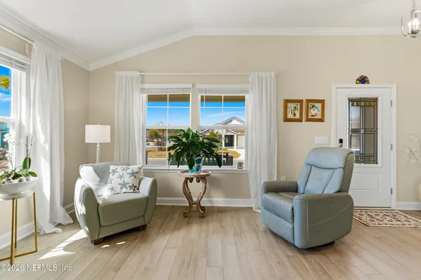 a view of a dining room with furniture and wooden floor