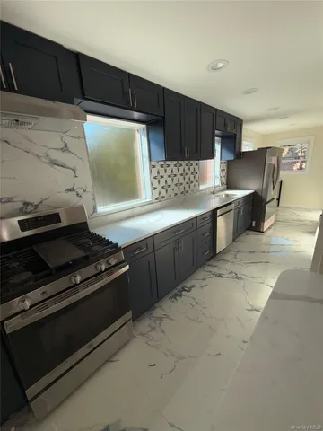 a kitchen with stainless steel appliances a stove and a refrigerator
