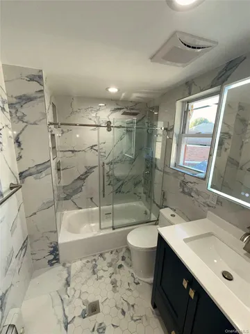 a bathroom with a sink mirror toilet and bathtub