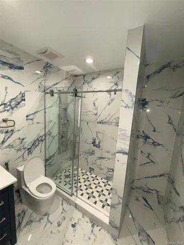 a bathroom with a toilet shower and a shower