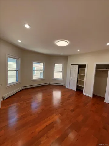 an empty room with windows and closet