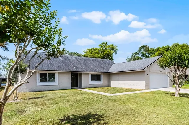 a view of a house with a backyard