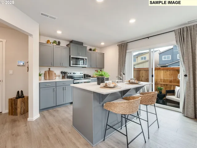 a kitchen with a table chairs refrigerator and a sink
