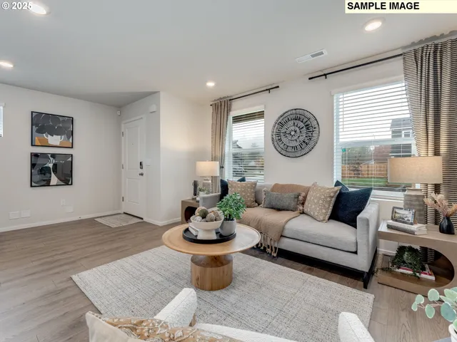 a living room with furniture a window and a table