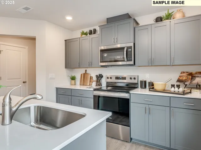 a kitchen with sink cabinets and stainless steel appliances
