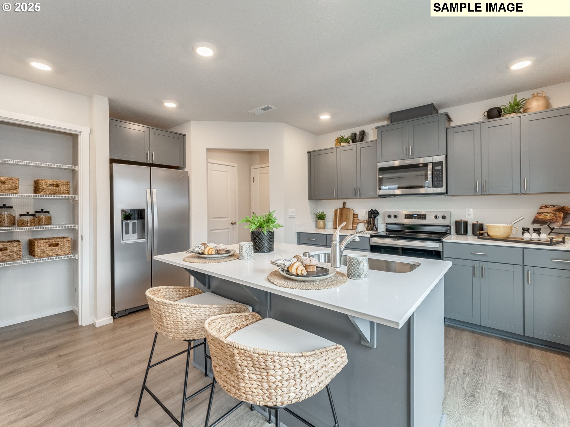 1107 Southeast 193rd Place Camas, WA 98607 - Photo 10 of 31 a kitchen with a sink a kitchen island and stainless steel appliances