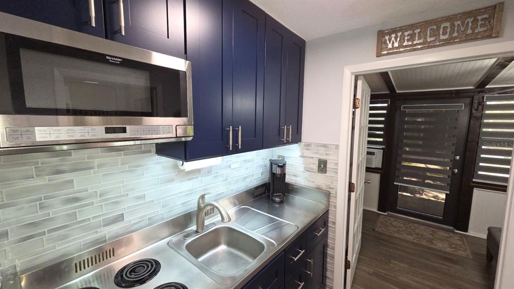 3200 River Ranch Boulevard, Unit 303 River Ranch, FL 33867 - Photo 2 of 16 a kitchen with granite countertop a stove and a microwave