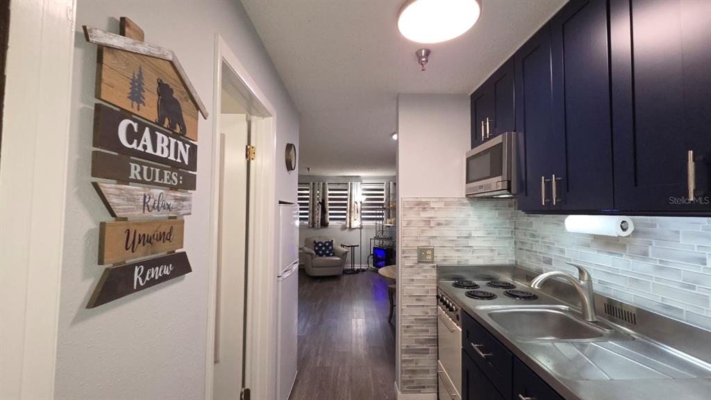 3200 River Ranch Boulevard, Unit 303 River Ranch, FL 33867 - Photo 3 of 16 a kitchen with stainless steel appliances granite countertop a sink stove and cabinets