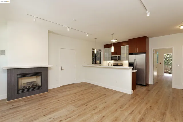 a kitchen with a refrigerator and a stove top oven