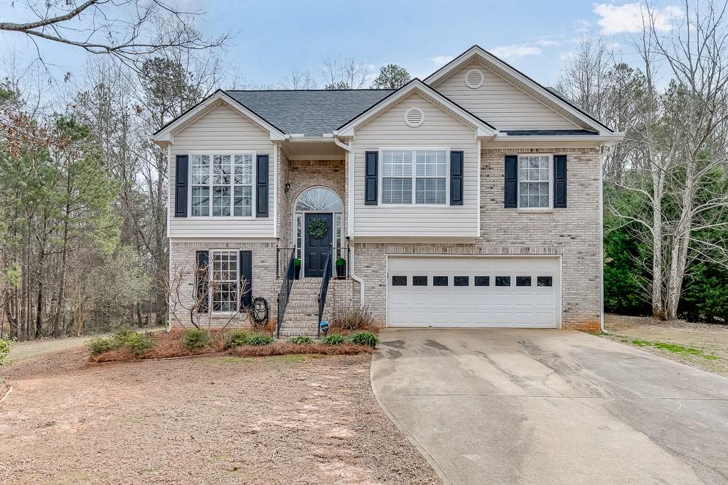 1023 Easy Street Winder, GA 30680 - Photo 1 of 1 a front view of a house with a yard and garage
