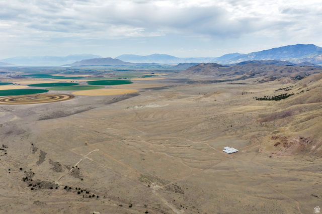 12800 South Crooked Cyn Road South Elberta, UT 84626 - Photo 25 of 48 Expansive land parcel featuring a visible white-roofed structure, surrounded by natural desert terrain and distant mountains