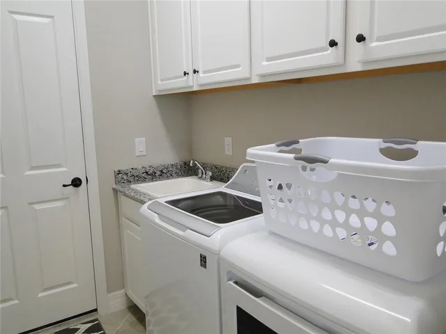 a kitchen with stainless steel appliances granite countertop a refrigerator and a stove