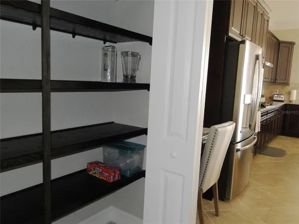 a kitchen with granite countertop a refrigerator stove top oven a sink and dishwasher