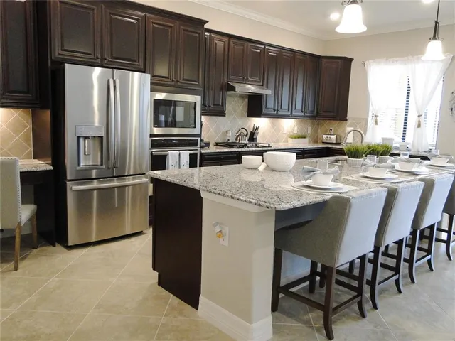 a living room with furniture a large mirror and a chandelier