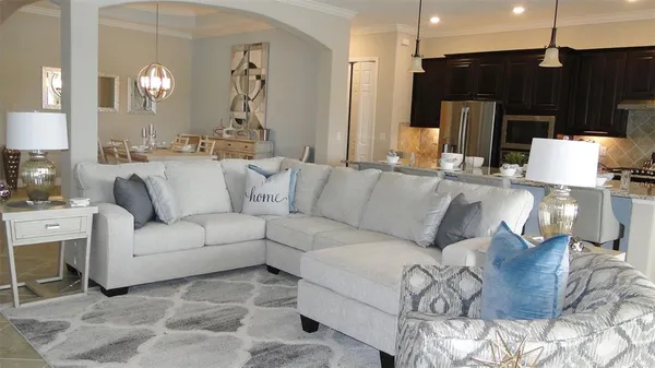 a living room with stainless steel appliances kitchen island granite countertop furniture and a fireplace