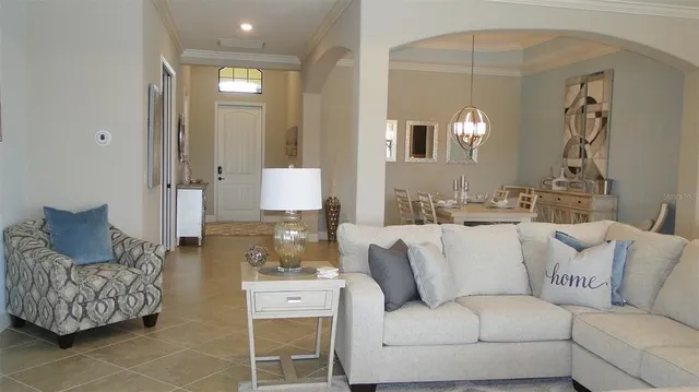 a living room with furniture and a mirror