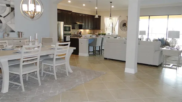 a dining hall with stainless steel appliances a table and chairs