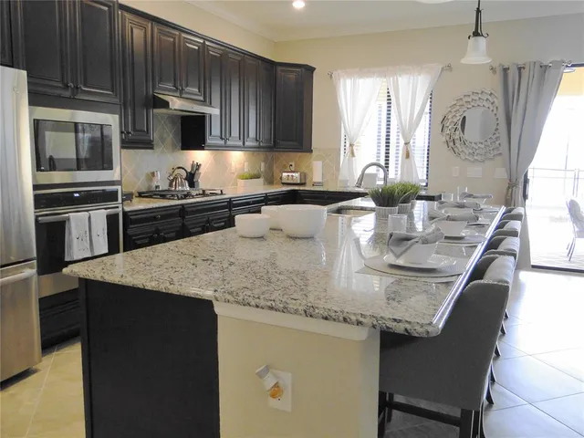 a bathroom with a granite countertop sink a mirror and a shower