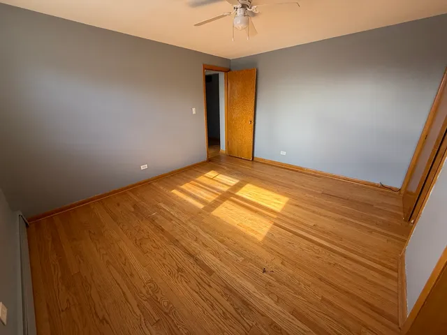 a view of an empty room and wooden floor