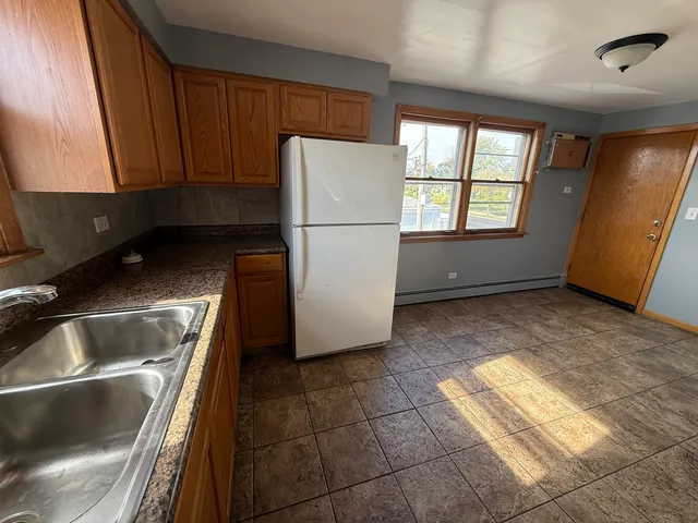 a kitchen with a refrigerator and a sink