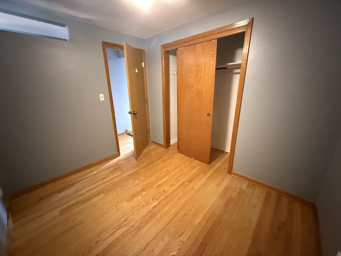 3556 North Nagle Avenue, Unit 2W Chicago, IL 60634 - Photo 9 of 14 a view of empty room with wooden floor