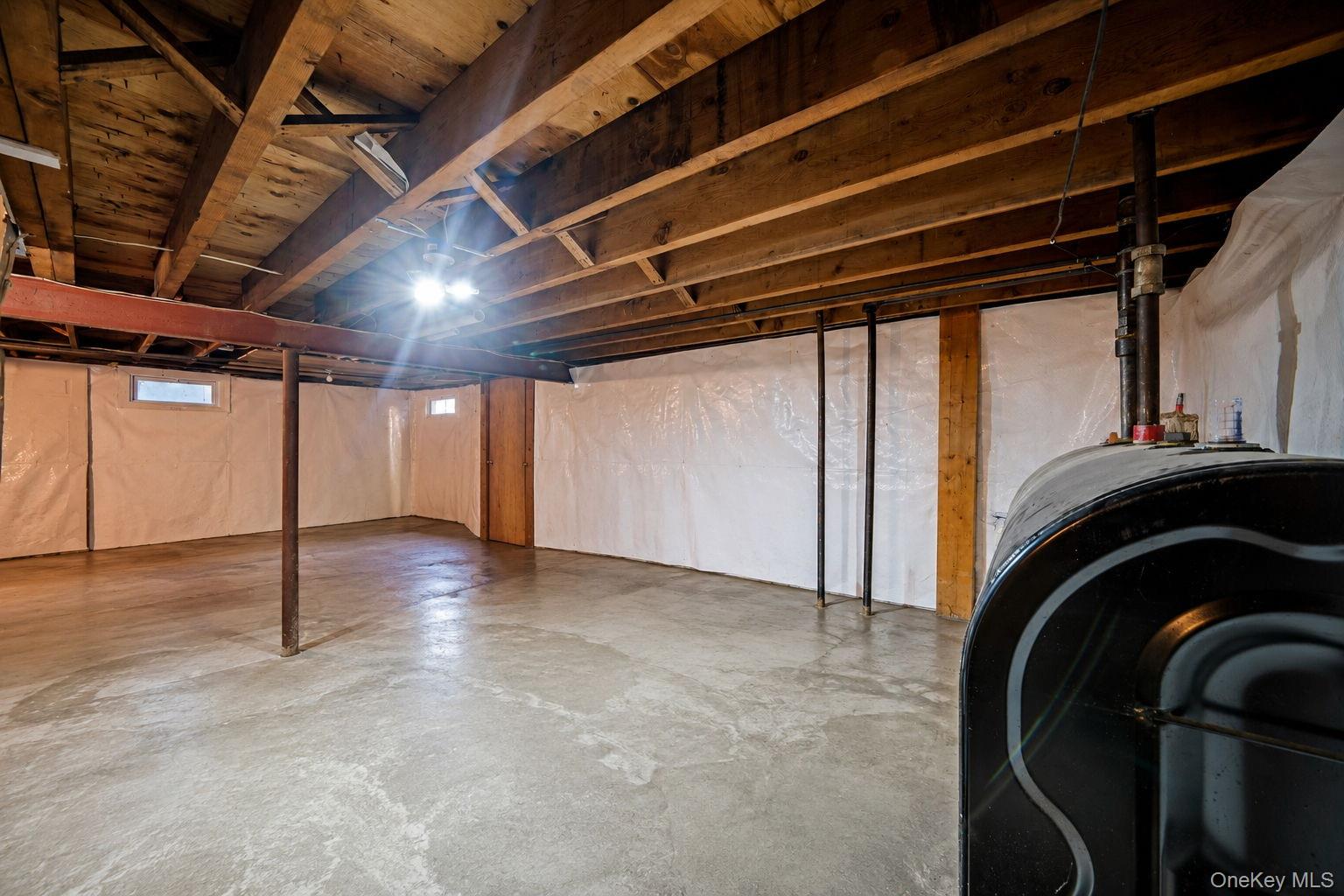 31 Crooked Hill Road Huntington, NY 11743 - Photo 26 of 32 Spacious unfinished basement featuring exposed wood ceiling joists, concrete flooring, and perimeter wall insulation