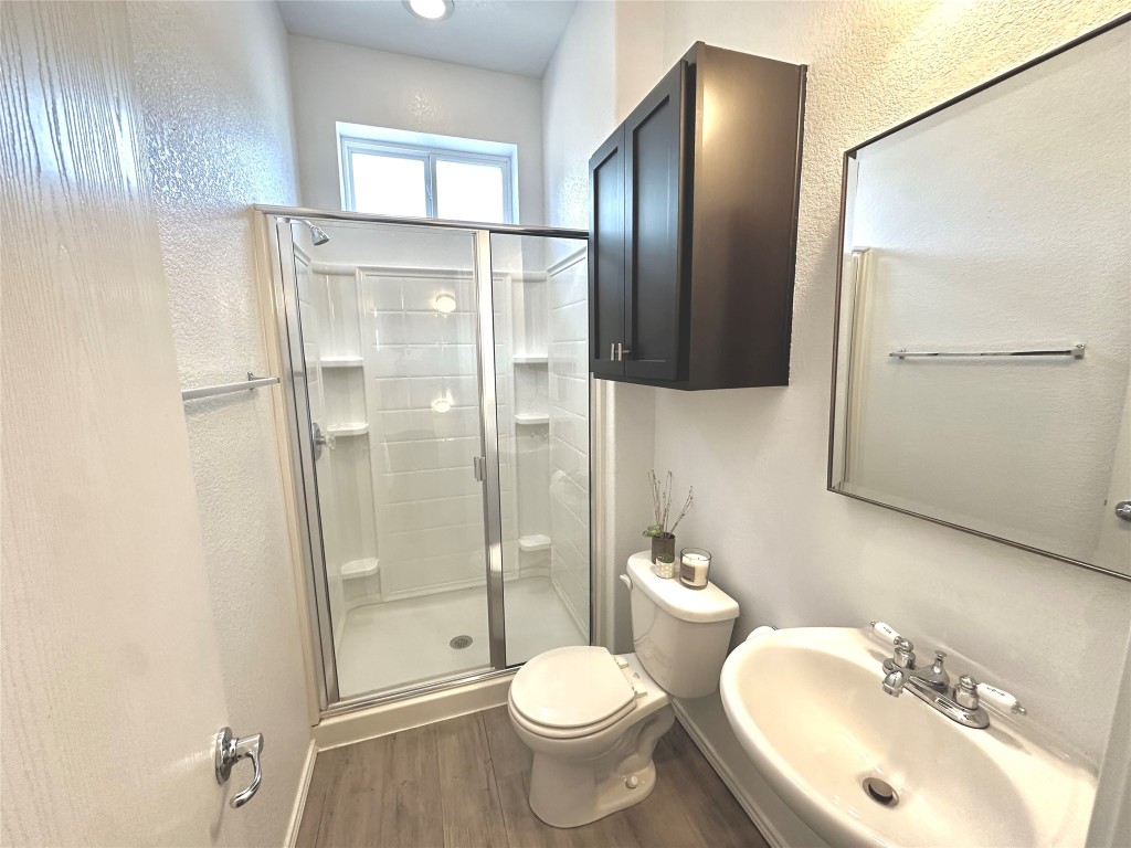 4323 Nitschke Street Austin, TX 78723 - Photo 5 of 11 a bathroom with a toilet sink and shower