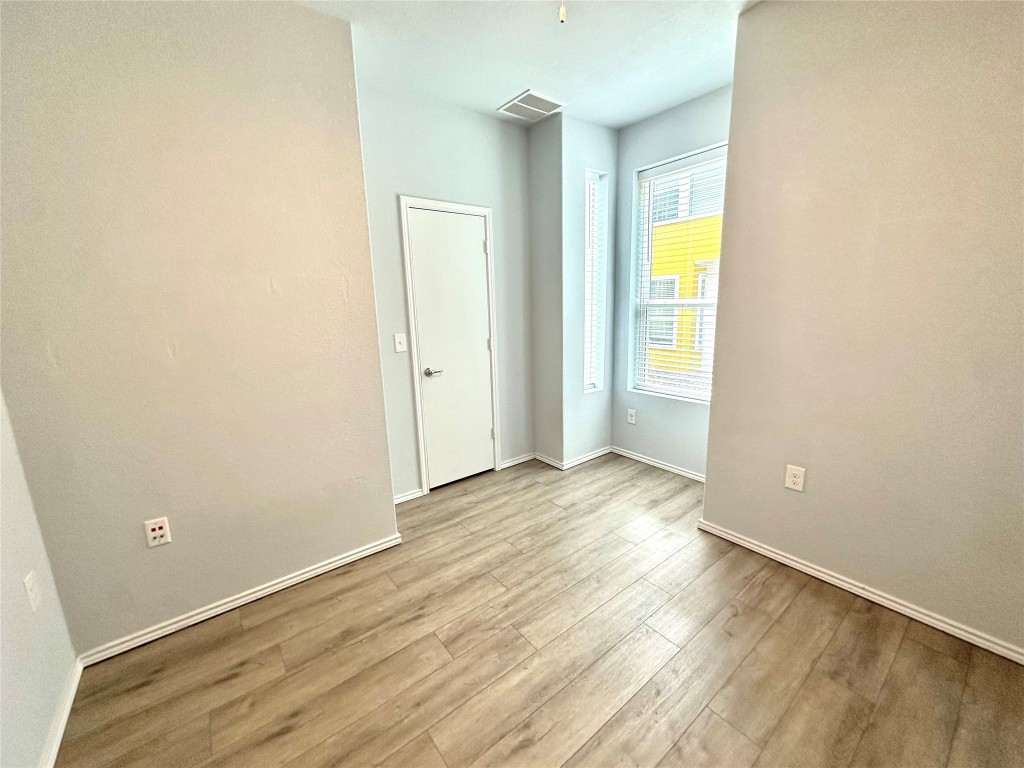 4323 Nitschke Street Austin, TX 78723 - Photo 6 of 11 an empty room with wooden floor and windows