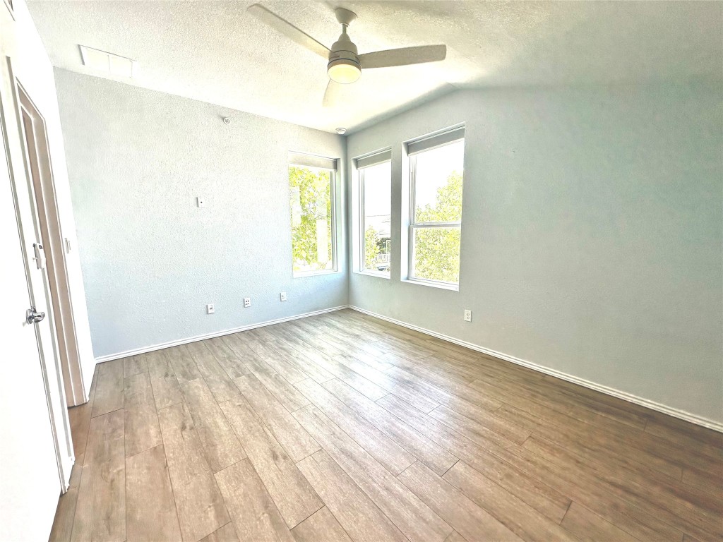 4323 Nitschke Street Austin, TX 78723 - Photo 10 of 11 an empty room with wooden floor and windows