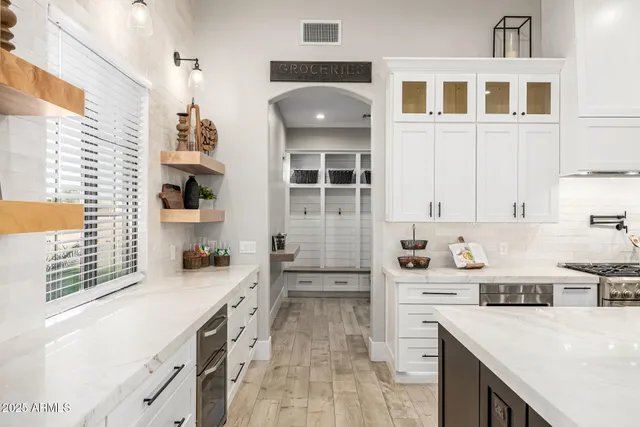 a view of a house with a patio and a yard