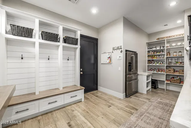 a view of a house with a yard and potted plants