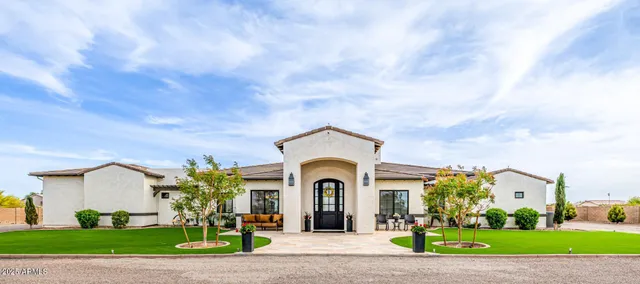 a large dining hall with stainless steel appliances kitchen island granite countertop a large center island a stove a dining table and chairs