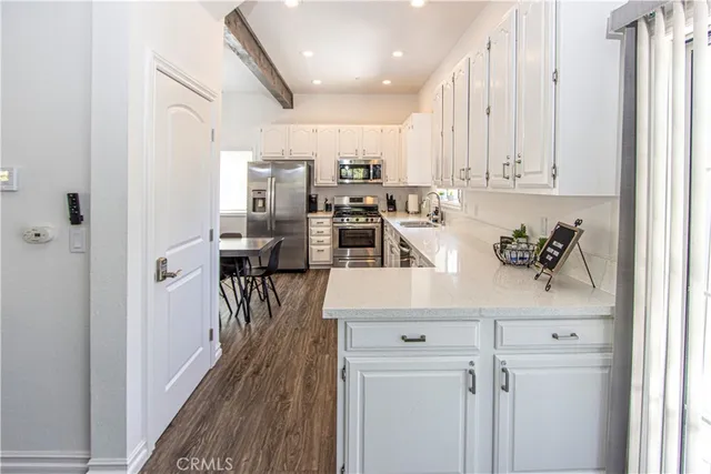 a kitchen with stainless steel appliances a refrigerator a stove a microwave and cabinets