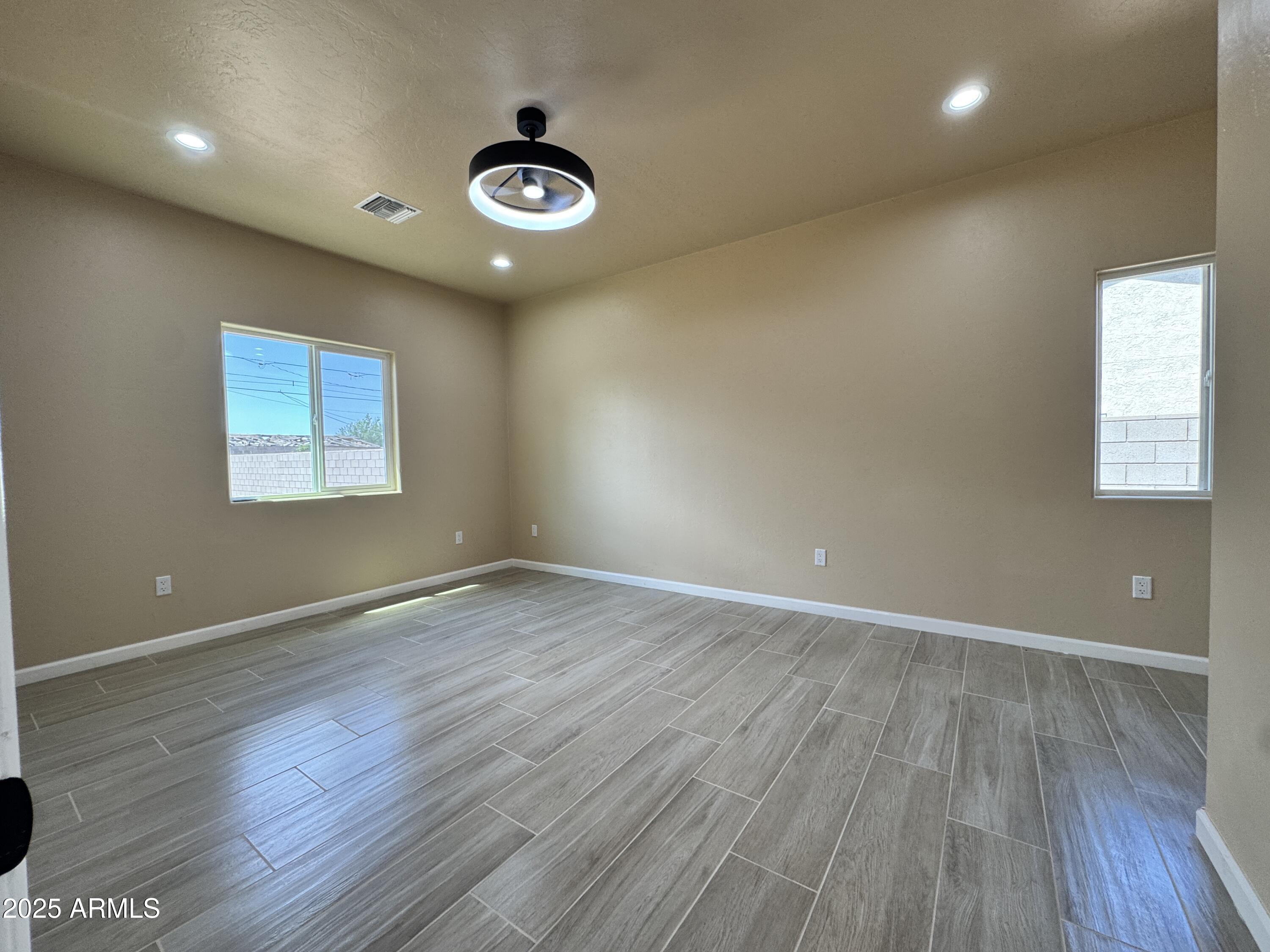 1457 East 23rd Street Douglas, AZ 85607 - Photo 13 of 23 an empty room with wooden floor and windows