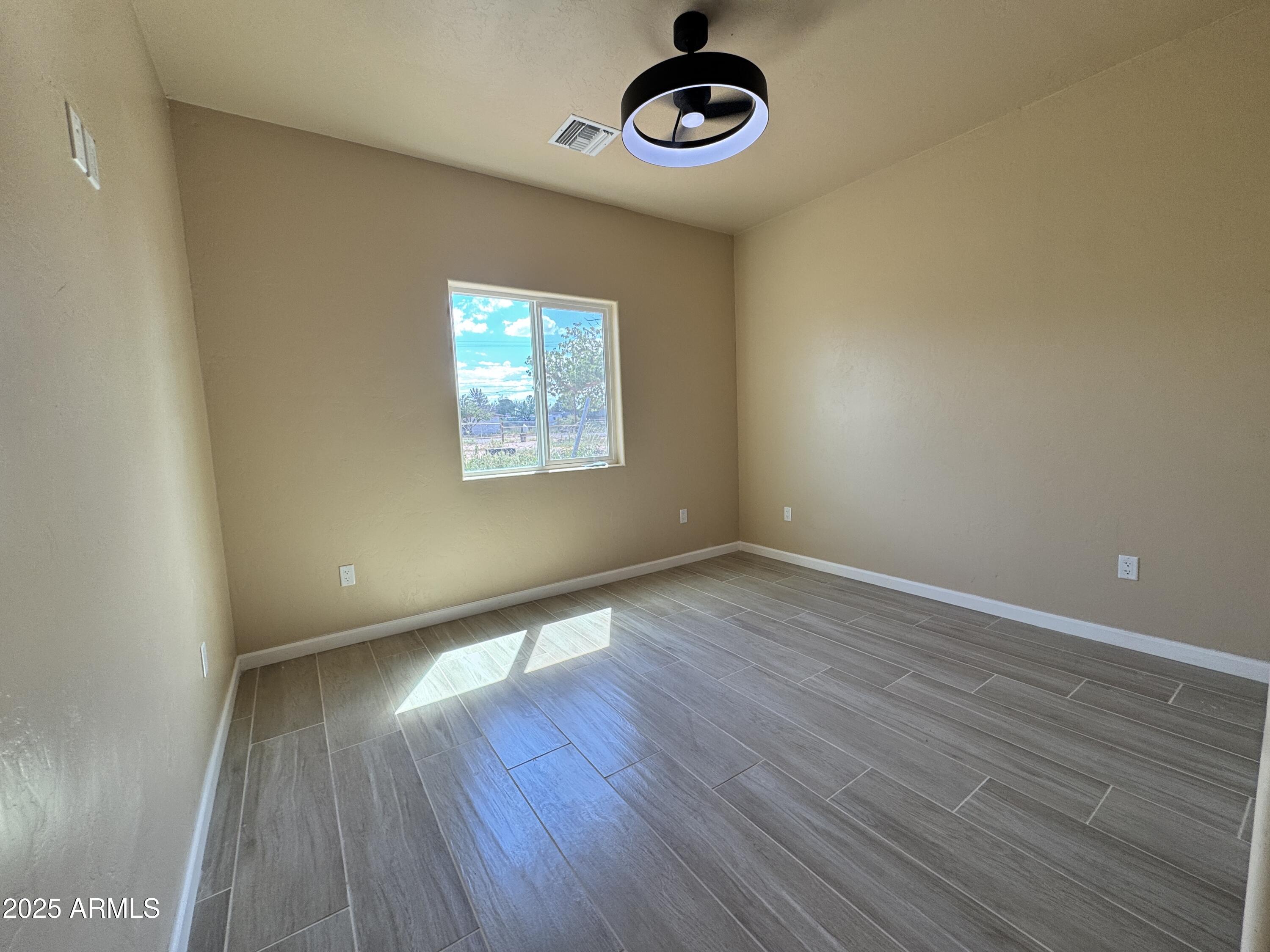 1457 East 23rd Street Douglas, AZ 85607 - Photo 9 of 23 wooden floor in an empty room with a window
