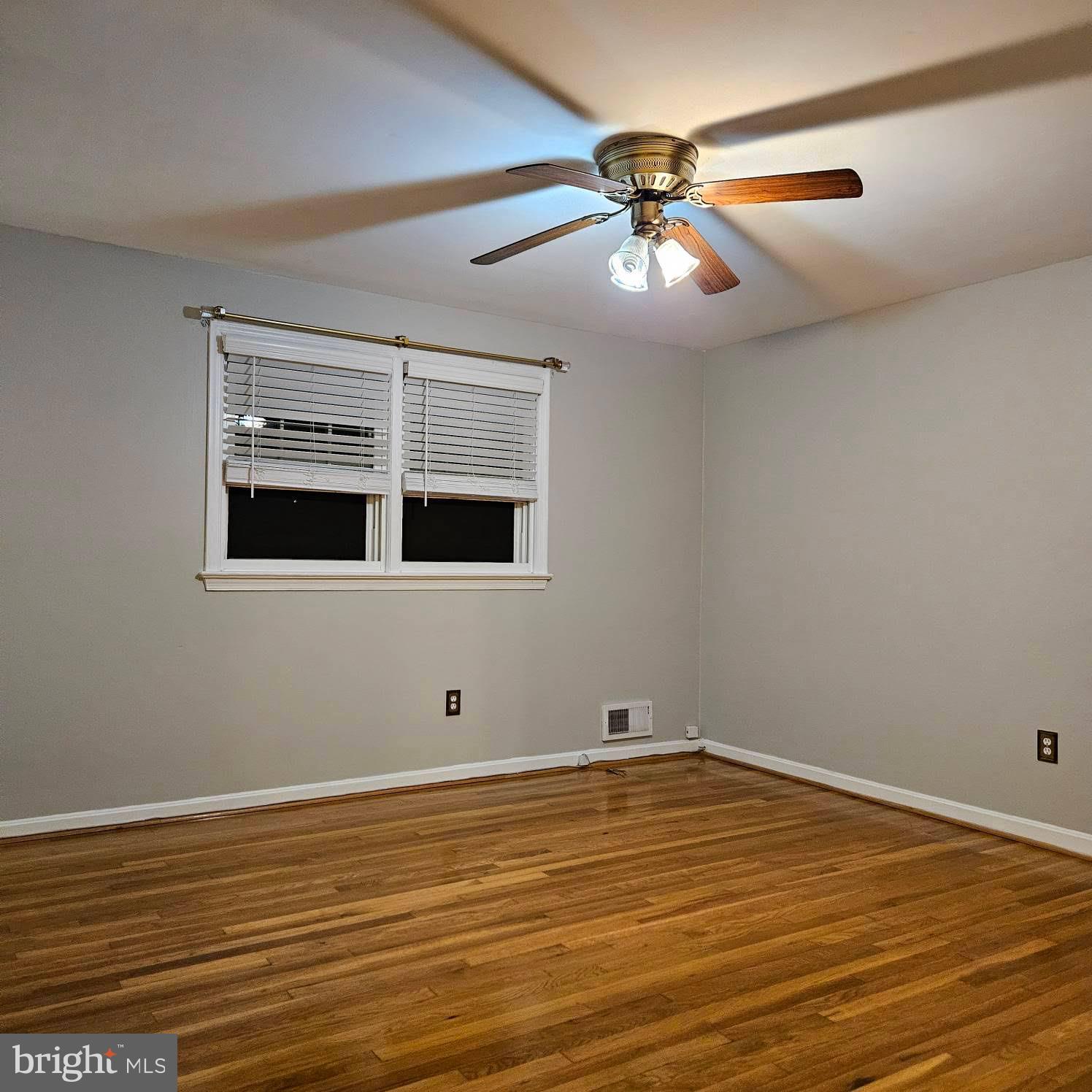 6602 Huntsman Boulevard Springfield, VA 22152 - Photo 11 of 14 a view of an empty room with window and wooden floor
